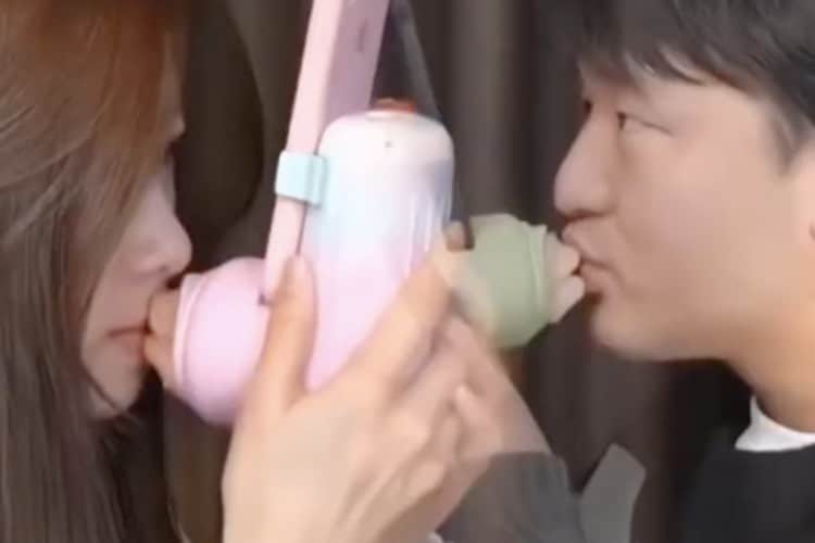 the taobao kissing device being used by a woman and a man